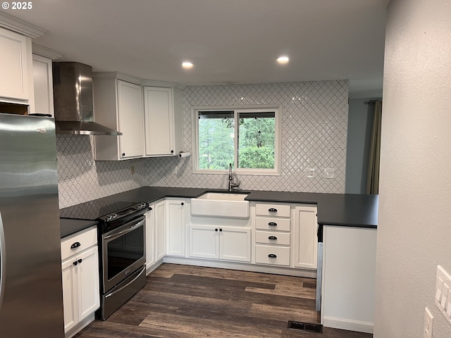 891 NE Bunyard Pl, Estacada, OR 97023 - kitchen with wall chimney range hood, appliances with stainless steel finishes, a sink, dark countertops, and decorative backsplash