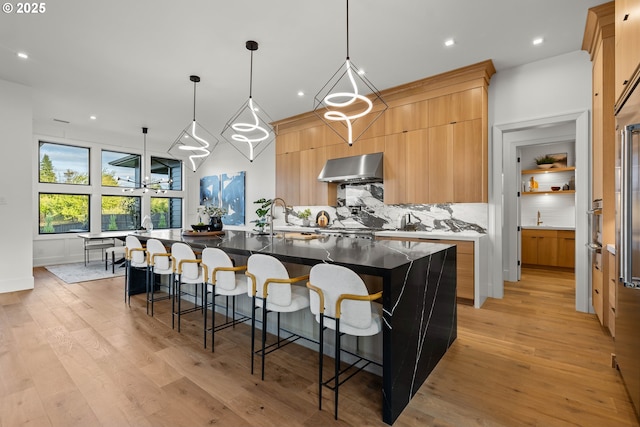 NE 43rd Cir Lot 5, Camas, WA 98607 - kitchen with range hood, modern cabinets, tasteful backsplash, a sink, and a large island with sink
