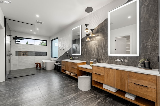 NE 43rd Cir Lot 5, Camas, WA 98607 - bathroom featuring a freestanding tub, two vanities, a walk in shower, tile walls, and decorative backsplash