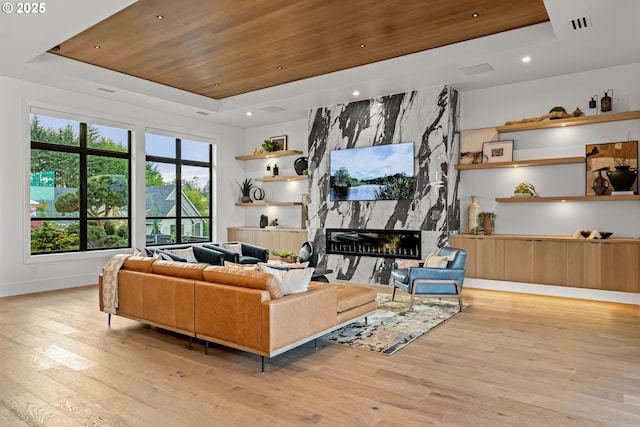 NE 43rd Cir Lot 5, Camas, WA 98607 - living room featuring a tray ceiling, light wood finished floors, wooden ceiling, baseboards, and a high end fireplace