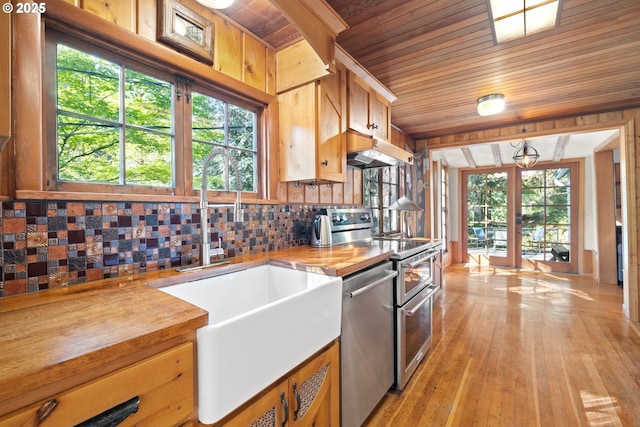 22345 S Poplar Rd, Estacada, OR 97023 - kitchen featuring appliances with stainless steel finishes, wood ceiling, wooden counters, under cabinet range hood, and tasteful backsplash