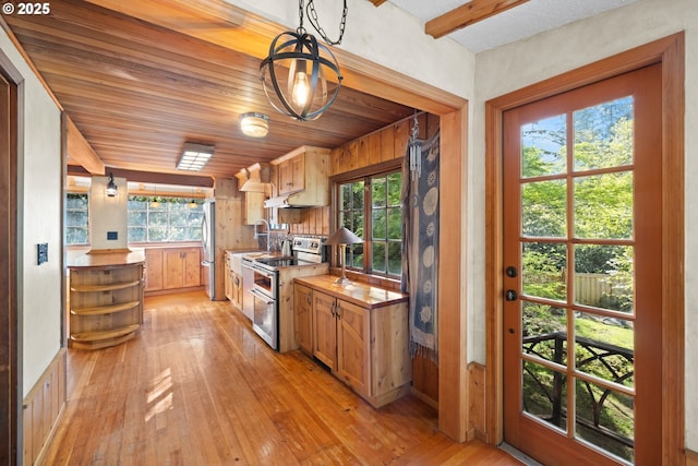 22345 S Poplar Rd, Estacada, OR 97023 - kitchen with appliances with stainless steel finishes, light wood-type flooring, pendant lighting, and butcher block counters