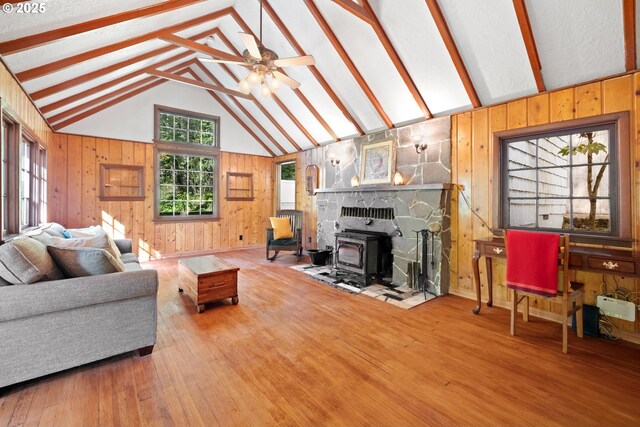 22345 S Poplar Rd, Estacada, OR 97023 - living area with wooden walls, hardwood / wood-style floors, a wood stove, and a ceiling fan