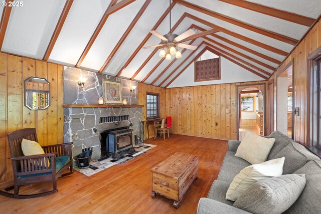 22345 S Poplar Rd, Estacada, OR 97023 - living room with wood walls, healthy amount of natural light, arched walkways, wood finished floors, and ceiling fan