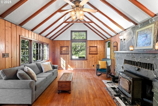 22345 S Poplar Rd, Estacada, OR 97023 - living area featuring a wood stove, wood walls, wood finished floors, and a ceiling fan