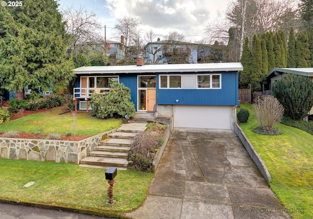 view of front of property featuring a garage and a front lawn