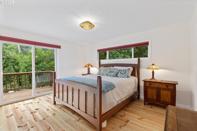 2245 SW Martha St, Portland, OR 97239 - bedroom featuring access to exterior and wood finished floors