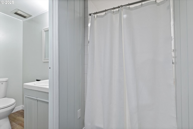 2245 SW Martha St, Portland, OR 97239 - full bath with wood finished floors, vanity, and a shower with curtain
