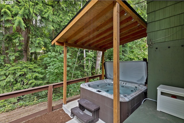 2245 SW Martha St, Portland, OR 97239 - wooden deck with a hot tub and a forest view