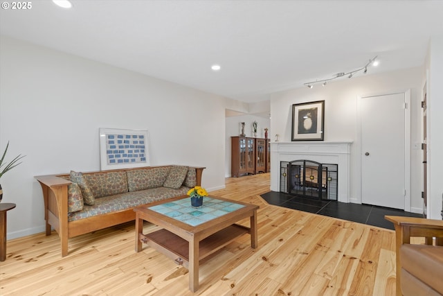 2245 SW Martha St, Portland, OR 97239 - living room featuring wood finished floors, recessed lighting, a fireplace with flush hearth, and track lighting