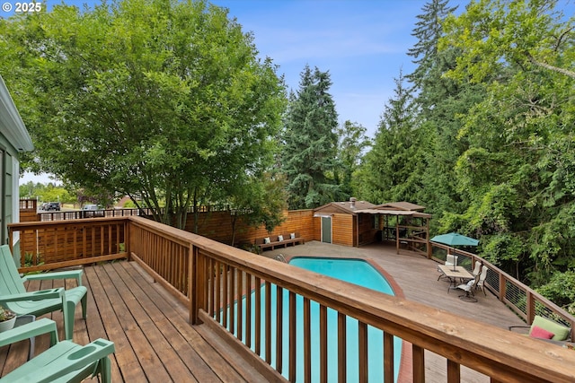 2245 SW Martha St, Portland, OR 97239 - wooden deck with a fenced backyard, a storage unit, and outdoor dining space