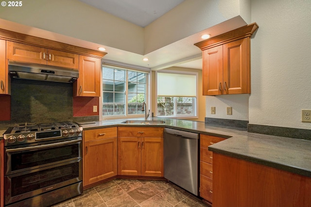 533 Fountain Ct, Keizer, OR 97303 - kitchen with appliances with stainless steel finishes, under cabinet range hood, dark countertops, backsplash, and brown cabinets