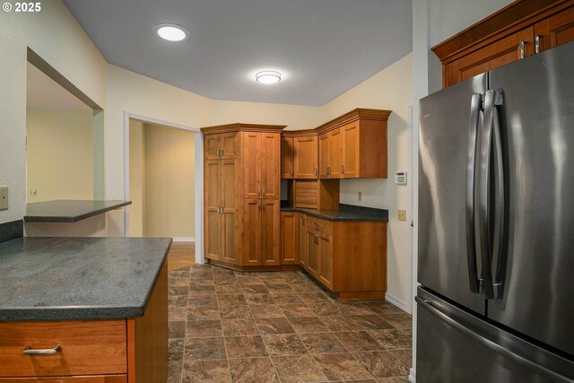 533 Fountain Ct, Keizer, OR 97303 - kitchen featuring freestanding refrigerator, brown cabinets, stone finish floors, and recessed lighting