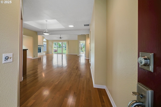 533 Fountain Ct, Keizer, OR 97303 - hallway with a tray ceiling, a textured wall, and wood finished floors
