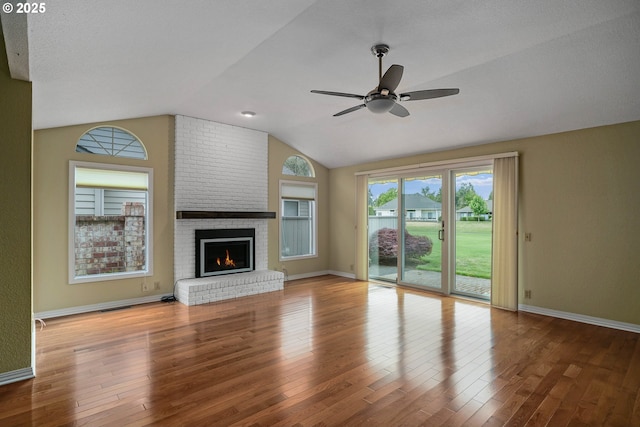 533 Fountain Ct, Keizer, OR 97303 - unfurnished living room featuring vaulted ceiling, ceiling fan, wood finished floors, and a brick fireplace