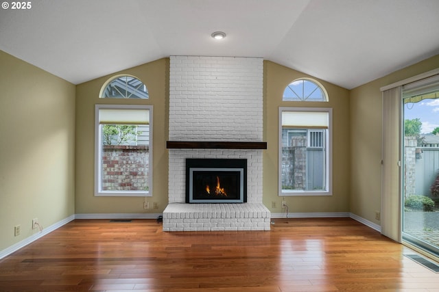 533 Fountain Ct, Keizer, OR 97303 - unfurnished living room with vaulted ceiling, wood finished floors, a fireplace, and healthy amount of natural light