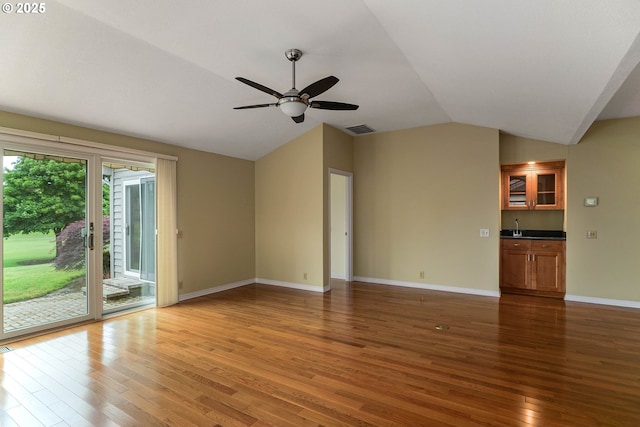 533 Fountain Ct, Keizer, OR 97303 - unfurnished living room with wood finished floors, vaulted ceiling, and ceiling fan