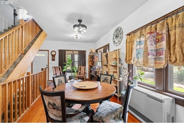 680 S Alfalfa St, Heppner, OR 97836 - dining room featuring healthy amount of natural light, wood finished floors, a chandelier, and stairway