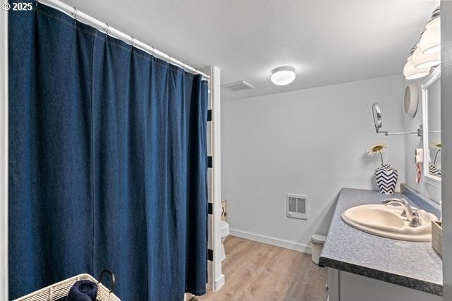 680 S Alfalfa St, Heppner, OR 97836 - full bath featuring vanity, wood finished floors, and curtained shower