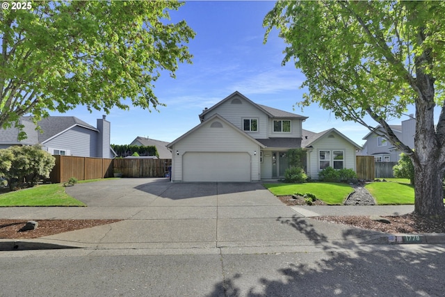 traditional-style house with fence, an attached garage, concrete driveway, and a front lawn
