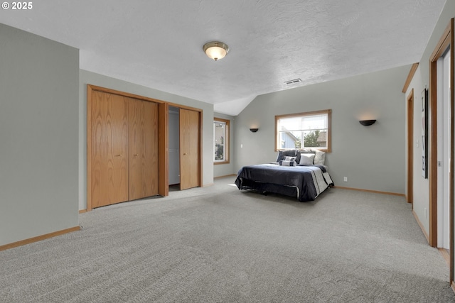 bedroom featuring visible vents, baseboards, and light colored carpet