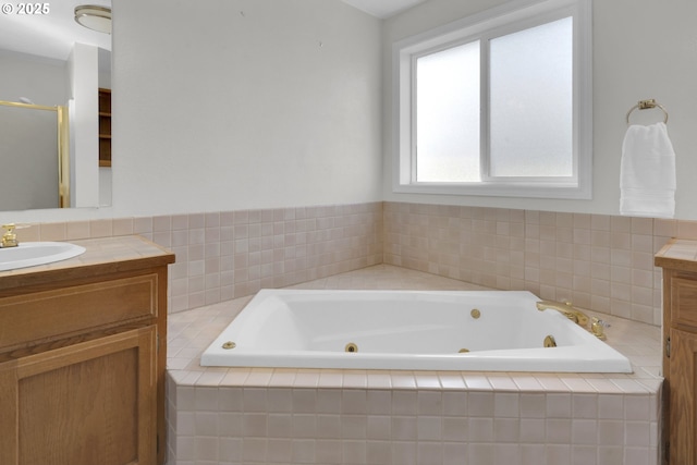 bathroom featuring a whirlpool tub, a shower stall, and vanity