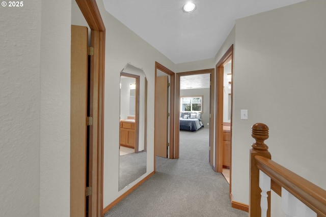 hall featuring light colored carpet and recessed lighting