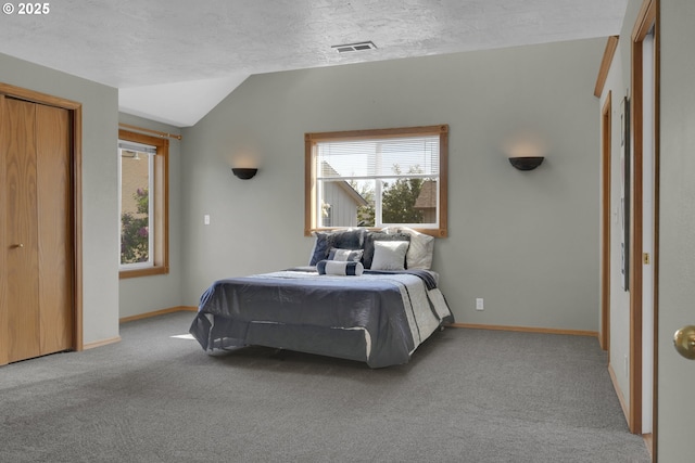 bedroom with visible vents, baseboards, carpet, and lofted ceiling