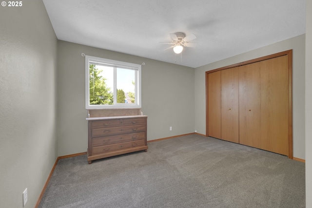 unfurnished bedroom featuring baseboards, a closet, light carpet, and ceiling fan
