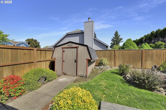 view of shed with a fenced backyard