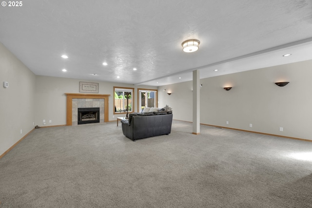 unfurnished living room with recessed lighting, baseboards, light colored carpet, and a tiled fireplace