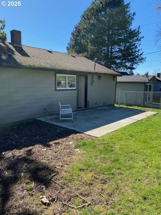 rear view of property featuring a patio area and a yard