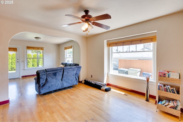 3265 SW 187th Ave, Beaverton, OR 97003 - living room with arched walkways, wood finished floors, and a ceiling fan
