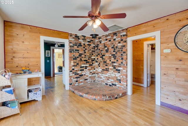 3265 SW 187th Ave, Beaverton, OR 97003 - spare room featuring wood walls, a ceiling fan, and light wood-style floors