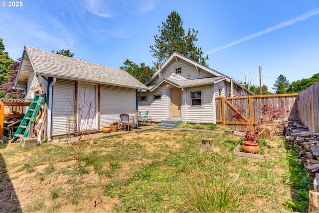 3265 SW 187th Ave, Beaverton, OR 97003 - rear view of property featuring a fenced backyard, entry steps, an outbuilding, and a shingled roof