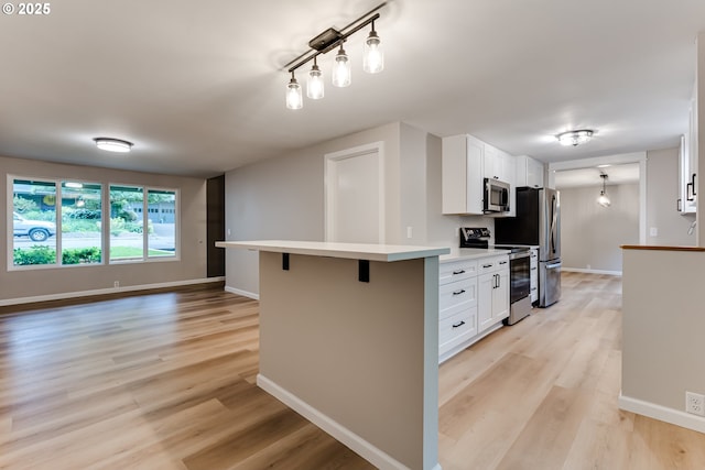 5120 Talisman St, Eugene, OR 97405 - kitchen with stainless steel appliances, light wood-type flooring, and baseboards