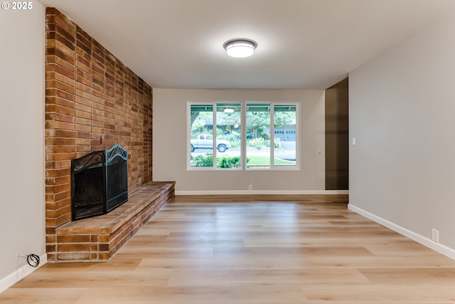 5120 Talisman St, Eugene, OR 97405 - unfurnished living room with a fireplace, wood finished floors, and baseboards