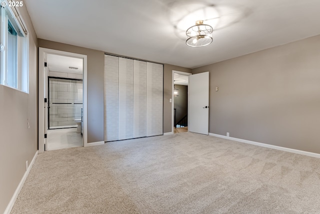 5120 Talisman St, Eugene, OR 97405 - unfurnished bedroom featuring carpet floors, connected bathroom, baseboards, and a closet