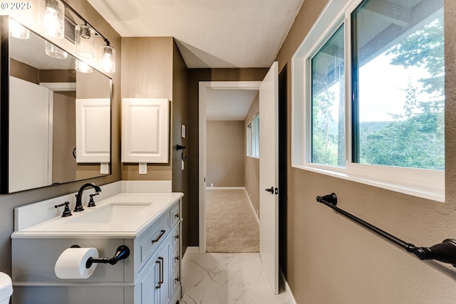 5120 Talisman St, Eugene, OR 97405 - bathroom with marble look tile flooring, vanity, baseboards, and toilet