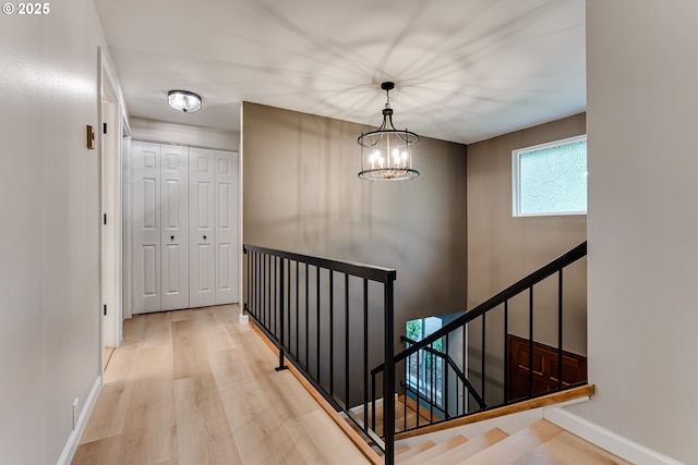 5120 Talisman St, Eugene, OR 97405 - stairs featuring wood finished floors, a chandelier, and baseboards