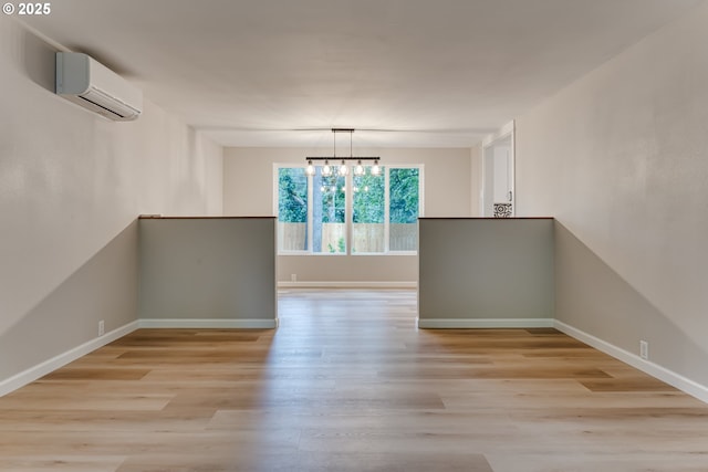 5120 Talisman St, Eugene, OR 97405 - spare room with a wall mounted AC, light wood finished floors, and baseboards