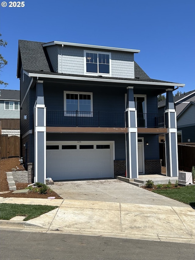 12198 SW Champlin Ln, Beaverton, OR 97007 - view of front facade featuring a balcony, concrete driveway, an attached garage, and roof with shingles