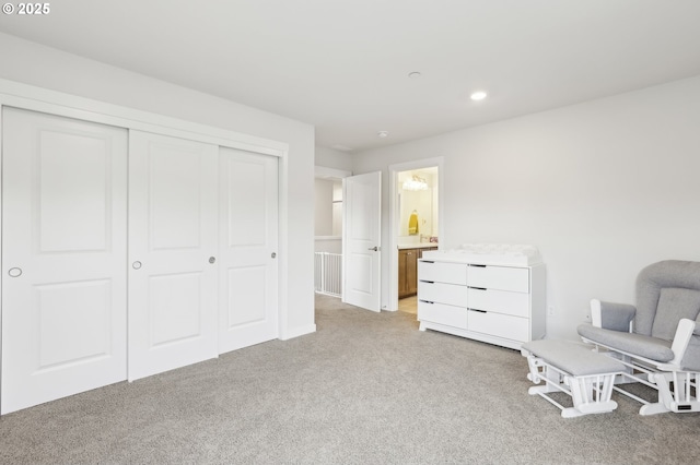 sitting room featuring light carpet