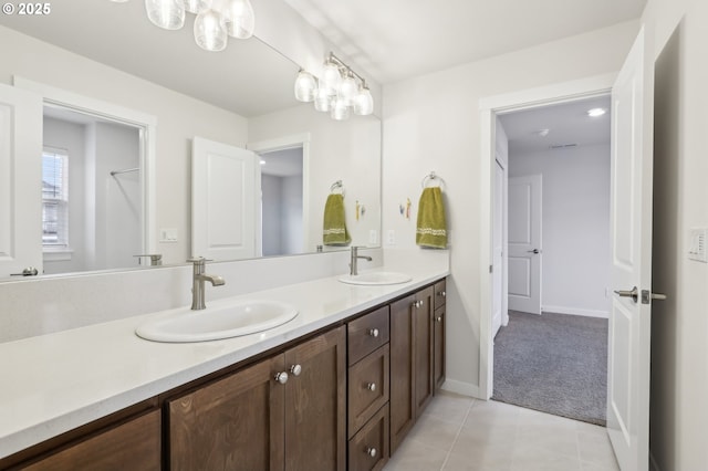 bathroom featuring a chandelier, vanity, and tile patterned floors