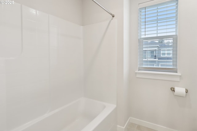 bathroom featuring tile patterned floors and  shower combination