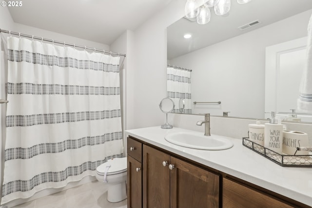 bathroom featuring tile patterned flooring, a shower with curtain, vanity, and toilet