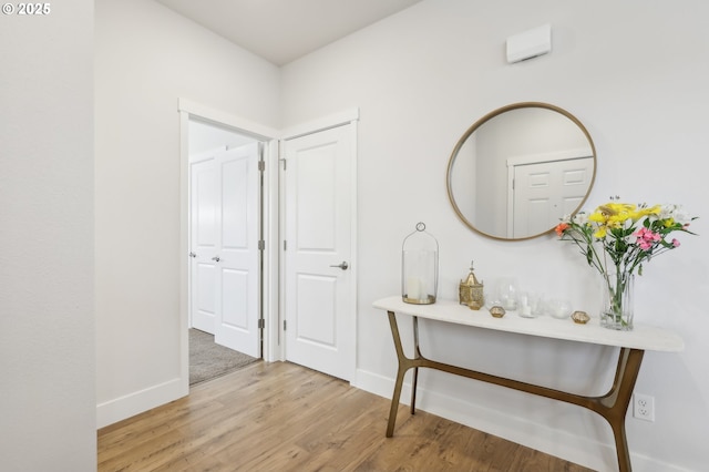 hallway with wood-type flooring