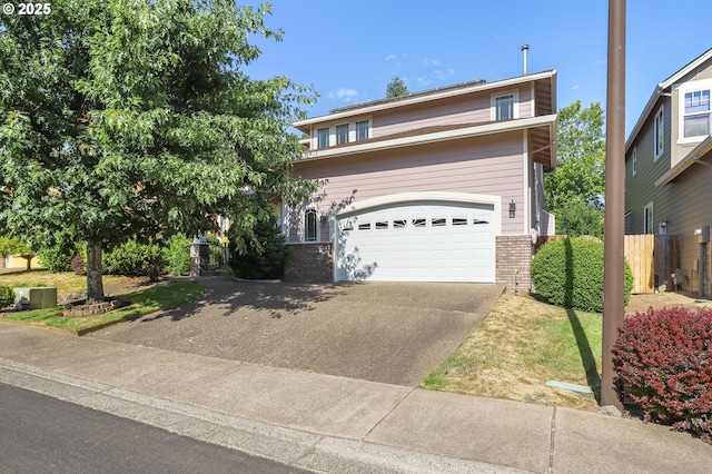 5274 NW Crady Ln, Portland, OR 97229 - view of front facade featuring brick siding, driveway, and a garage