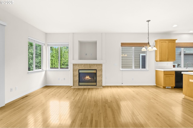 5274 NW Crady Ln, Portland, OR 97229 - unfurnished living room featuring light wood-style flooring, a fireplace, and recessed lighting