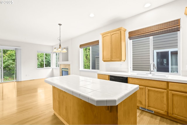 5274 NW Crady Ln, Portland, OR 97229 - kitchen with light wood-type flooring, recessed lighting, a chandelier, tile counters, and a center island